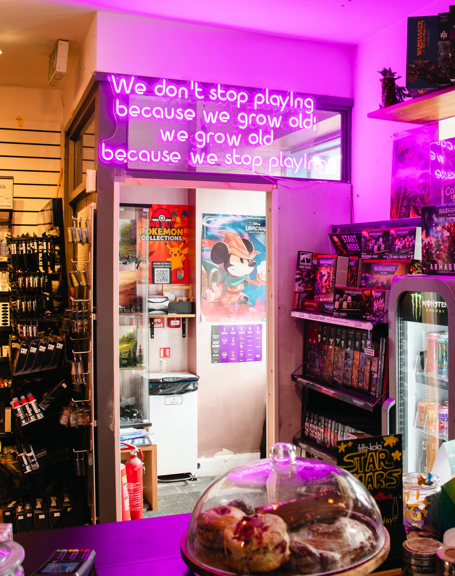 The neon sign and counter at Board & Brewed