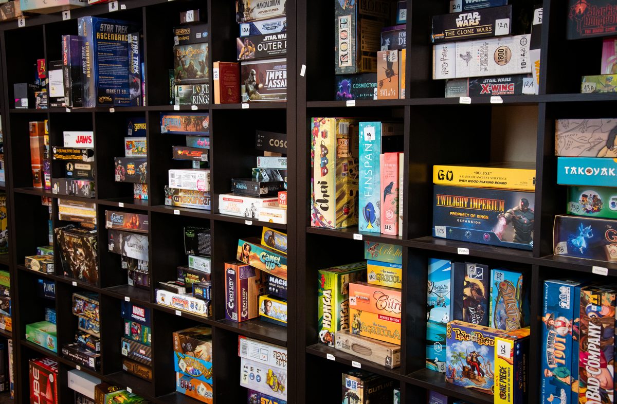Shelves of board games in the Board & Brewed library