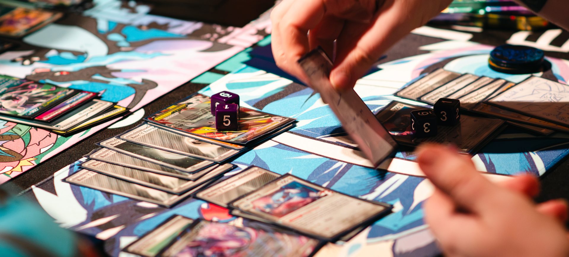 Pokémon cards and dice mid-game on a playmat at Board & Brewed